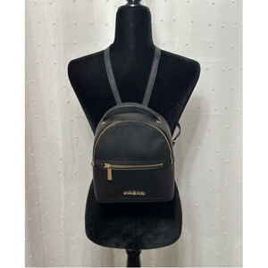 Michael Kors black backpack purse with gold accents.